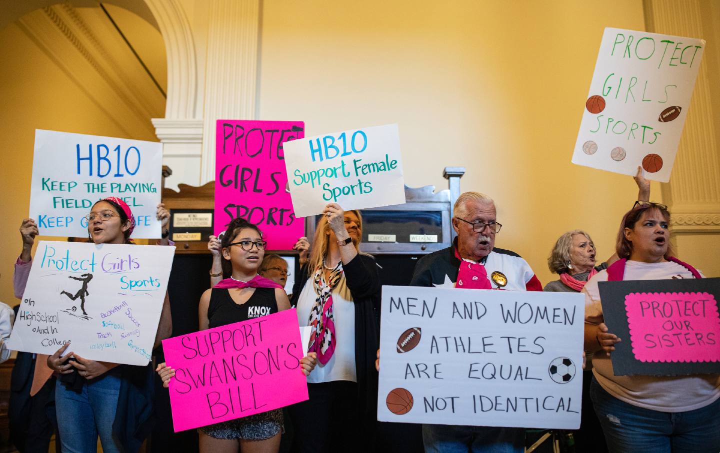 Demonstrators supporting restrictions on transgender student athletes