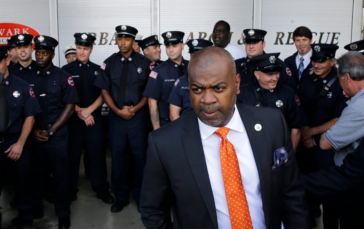 Ras Baraka in front a large group of uniformed fire fighters