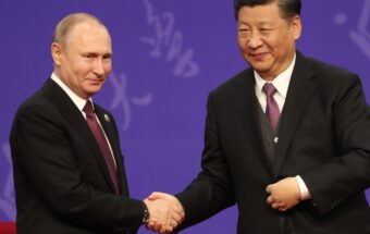 Russian President Vladimir Putin, left, shakes hands with Chinese President Xi Jinping, right, in April 2019 in Beijing, China.