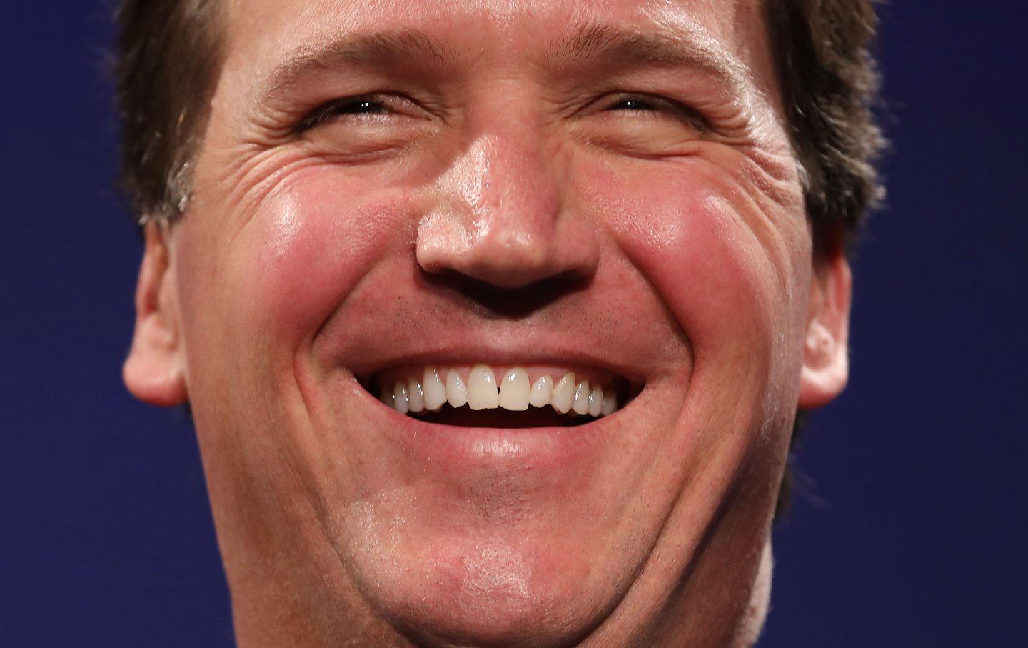 Tucker Carlson laughing