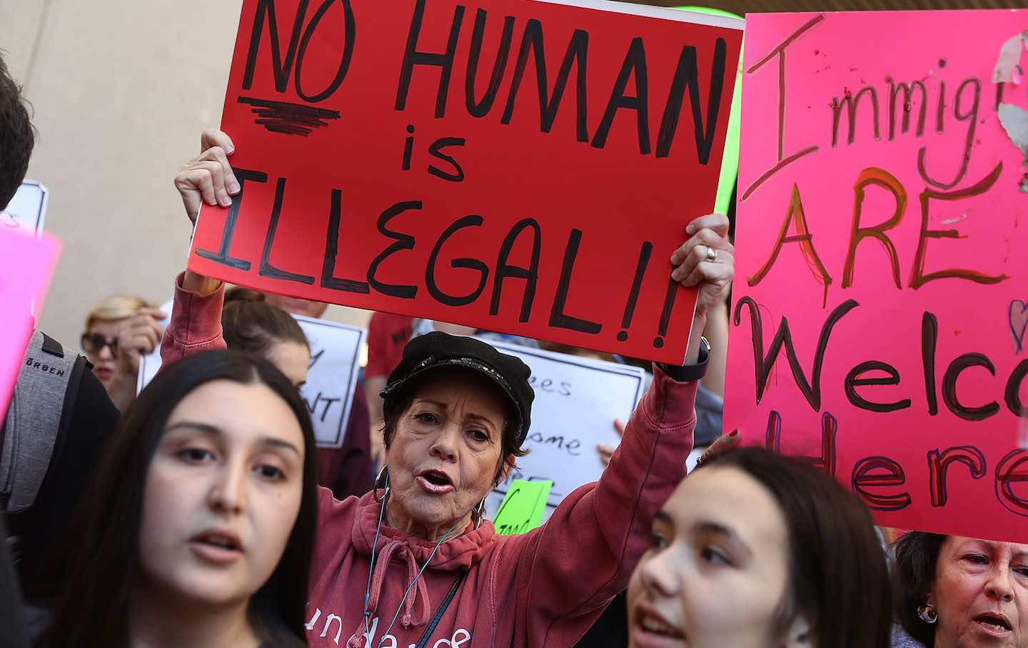 Protesters gather against Miami-Dade Mayor Carlos Gimenez's decision to abide by President Donald Trump's order to effectively abandon the county's stance as a 