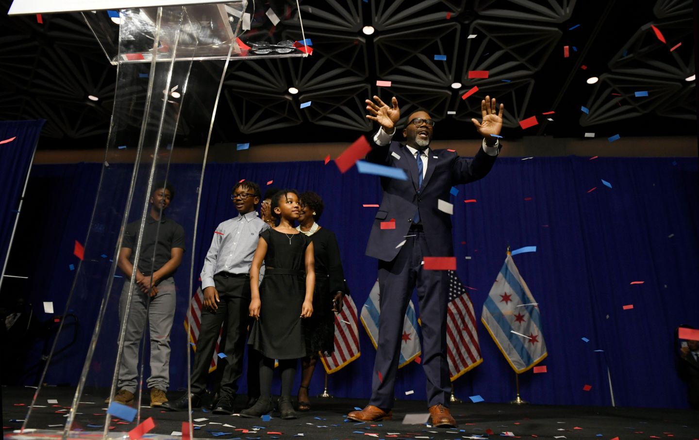 Brandon Johnson celebrates at podium