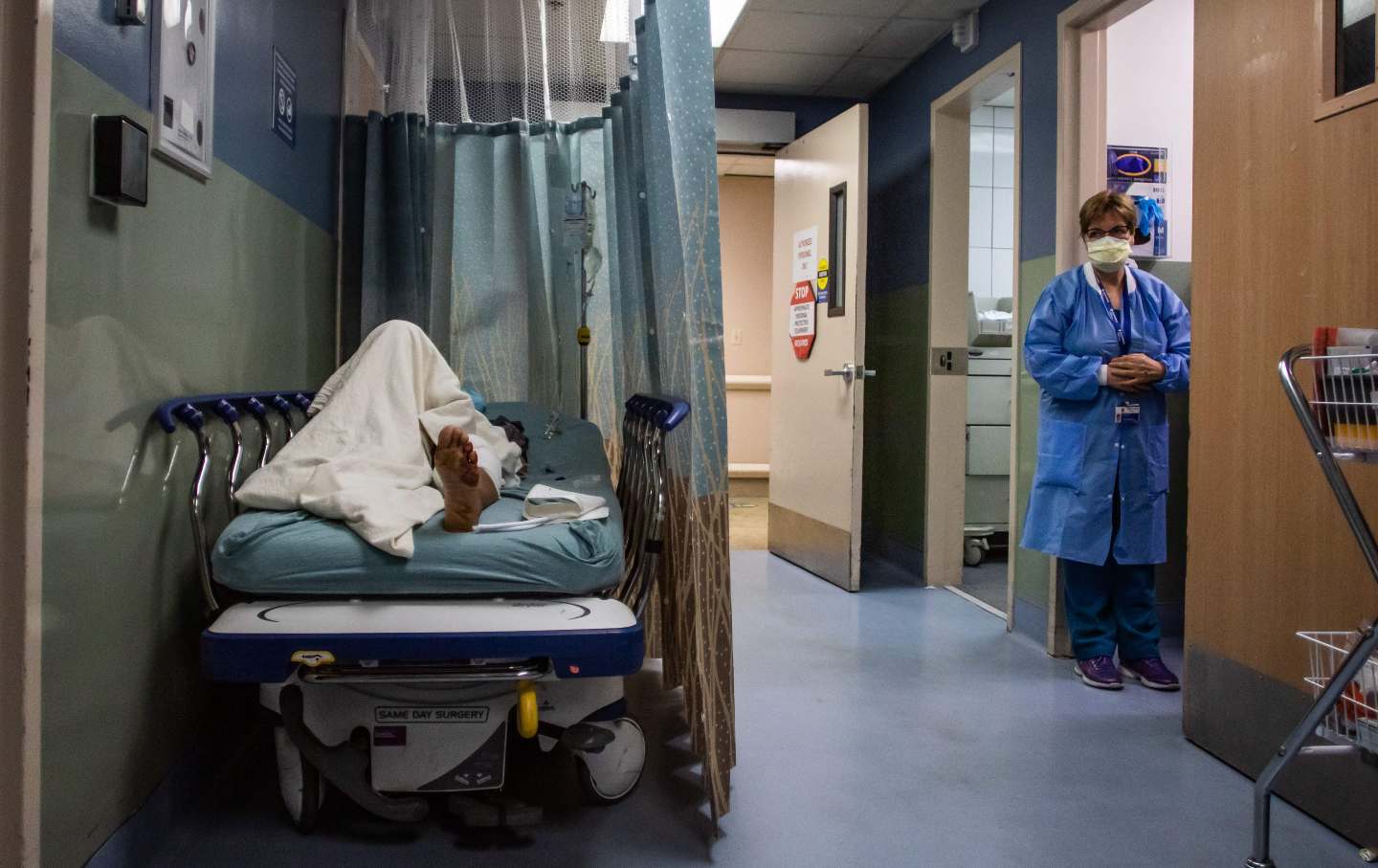 A patient rests in a corridor waiting for a room at Providence Cedars–Sinai Tarzana Medical Center in California on January 3, 2021.