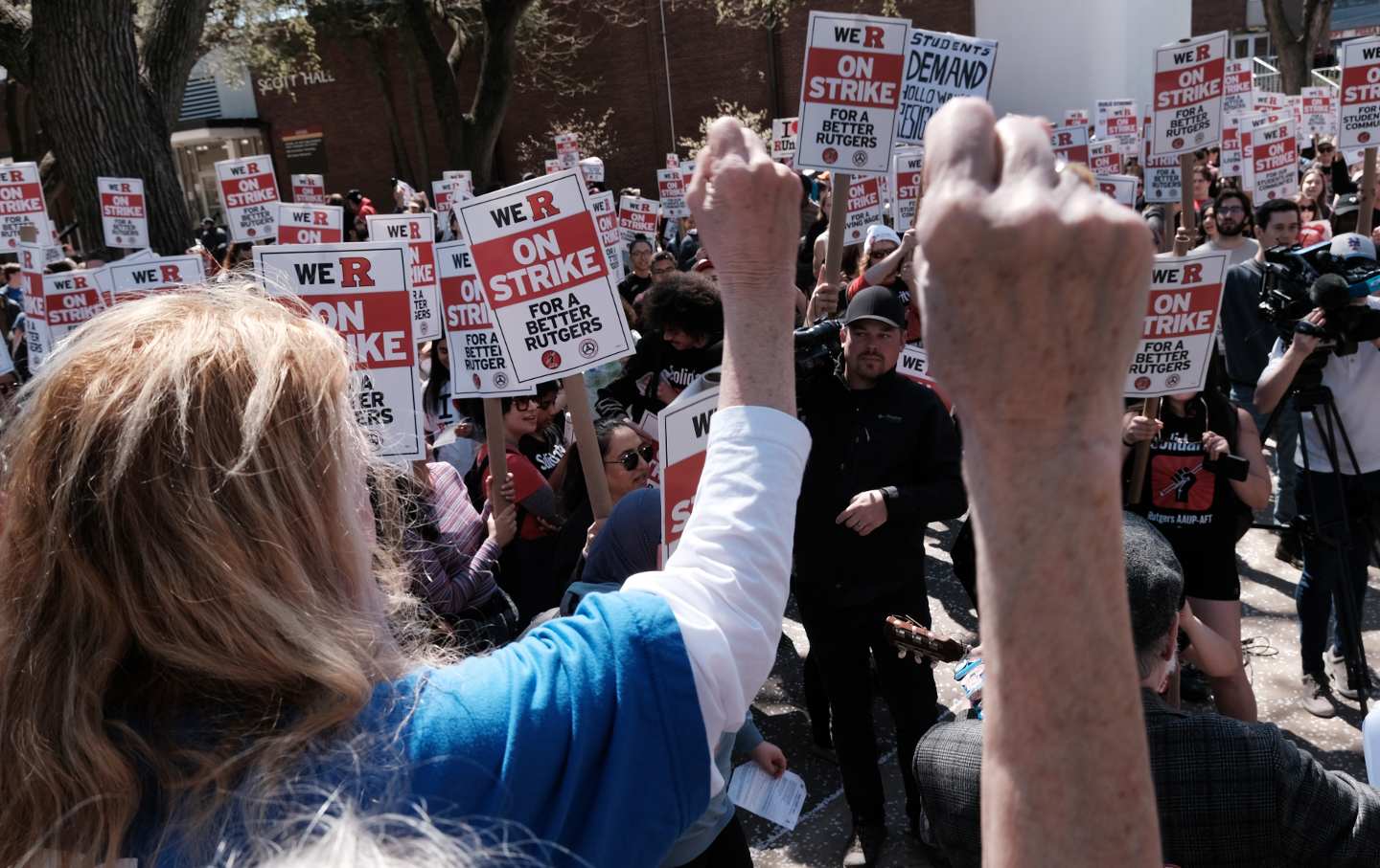 Rutgers students and faculty hold signs at a picket