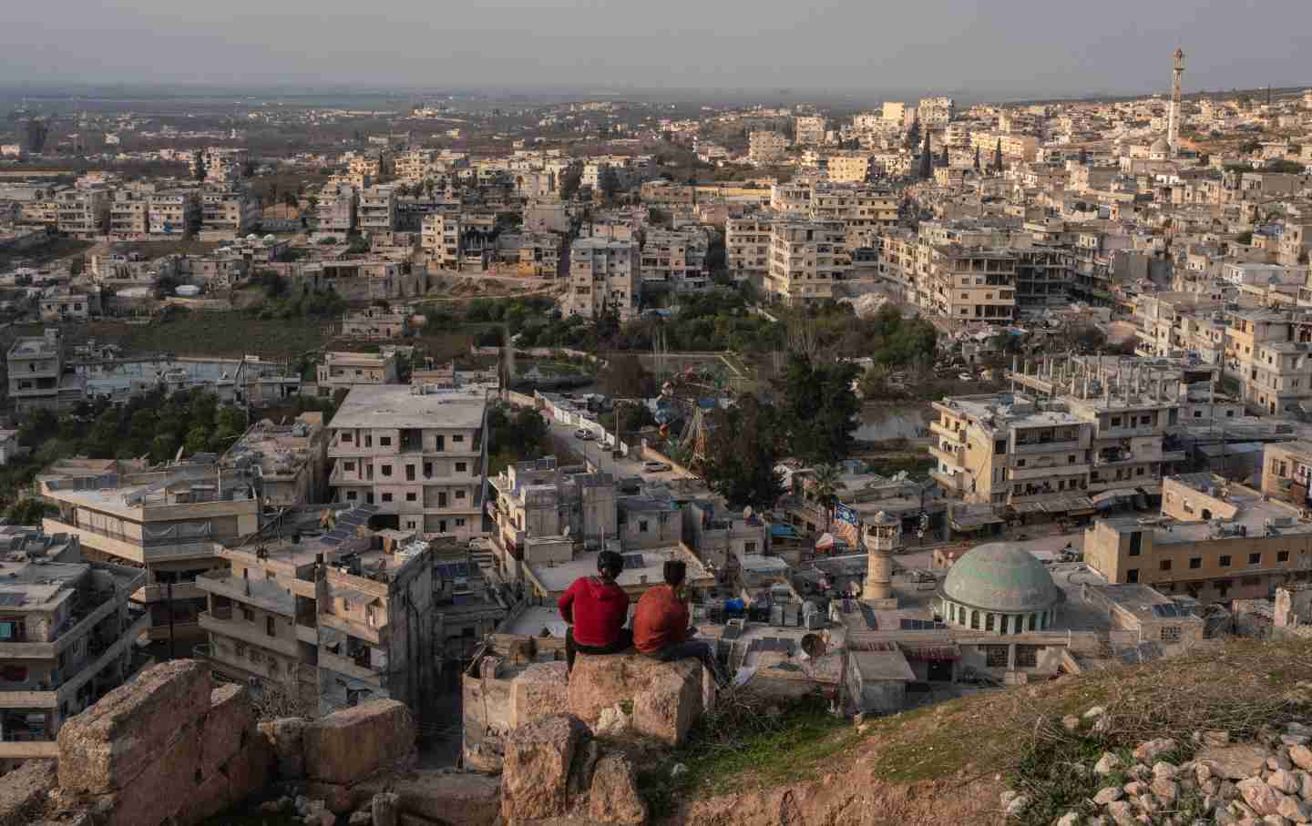 Two young Syrians sit at Harim Castle