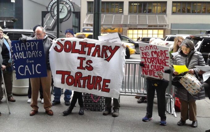 Advocates with the New York Campaign for Alternatives to Isolated Confinement rally outside Governor's Mario Cuomo's office in December 2018
