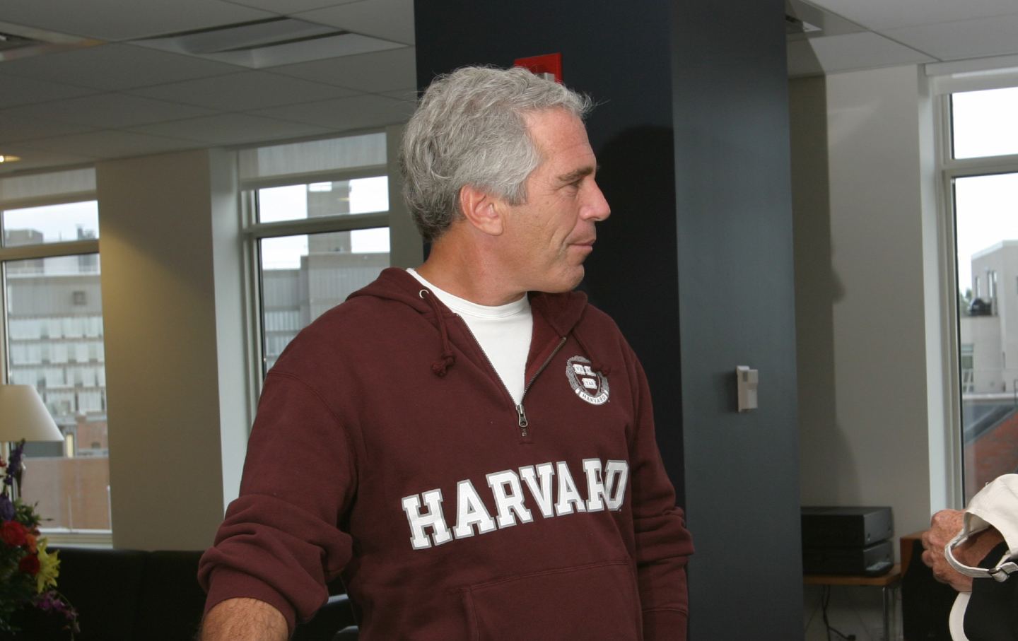 Jeffrey Epstein is photographed wearing a Harvard sweatshirt.