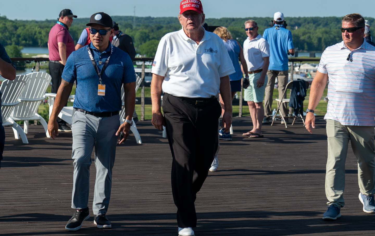 Walt Nauta, who was indicted on federal charges alongside Donald Trump, walks with his boss during the first round of the LIV Golf at Trump National Golf Club, Friday, May 26, 2023, in Sterling, Va.
