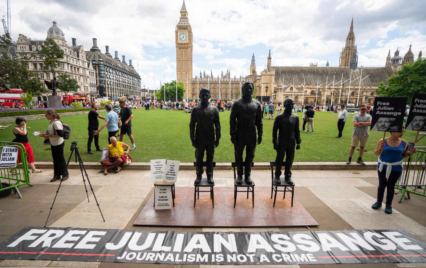 A sculpture called “Anything to Say,” which features life-sized bronze figures of whistleblowers (left-right) Edward Snowden, Julian Assange, and Chelsea Manning, is unveiled at Parliament Square, London, during a protest for Assange’s release from prison.