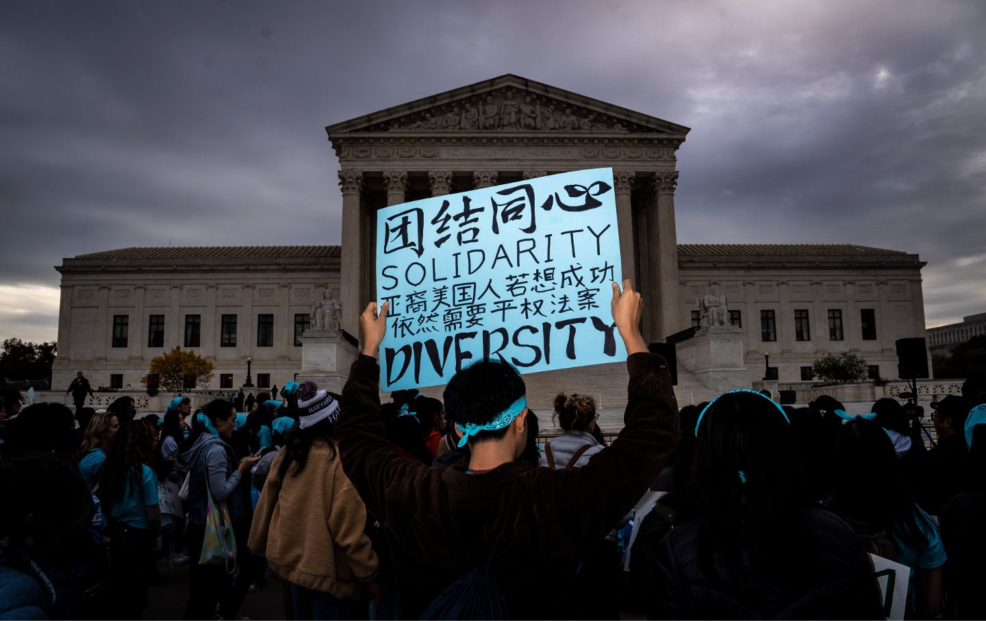 A protester holds a sign reading 