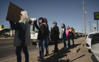 Protesters line the corner of Commerce and North Prince Street during a pro-choice rally held by Eastern New Mexico Rising in Clovis, N.M., on January 22, 2022.