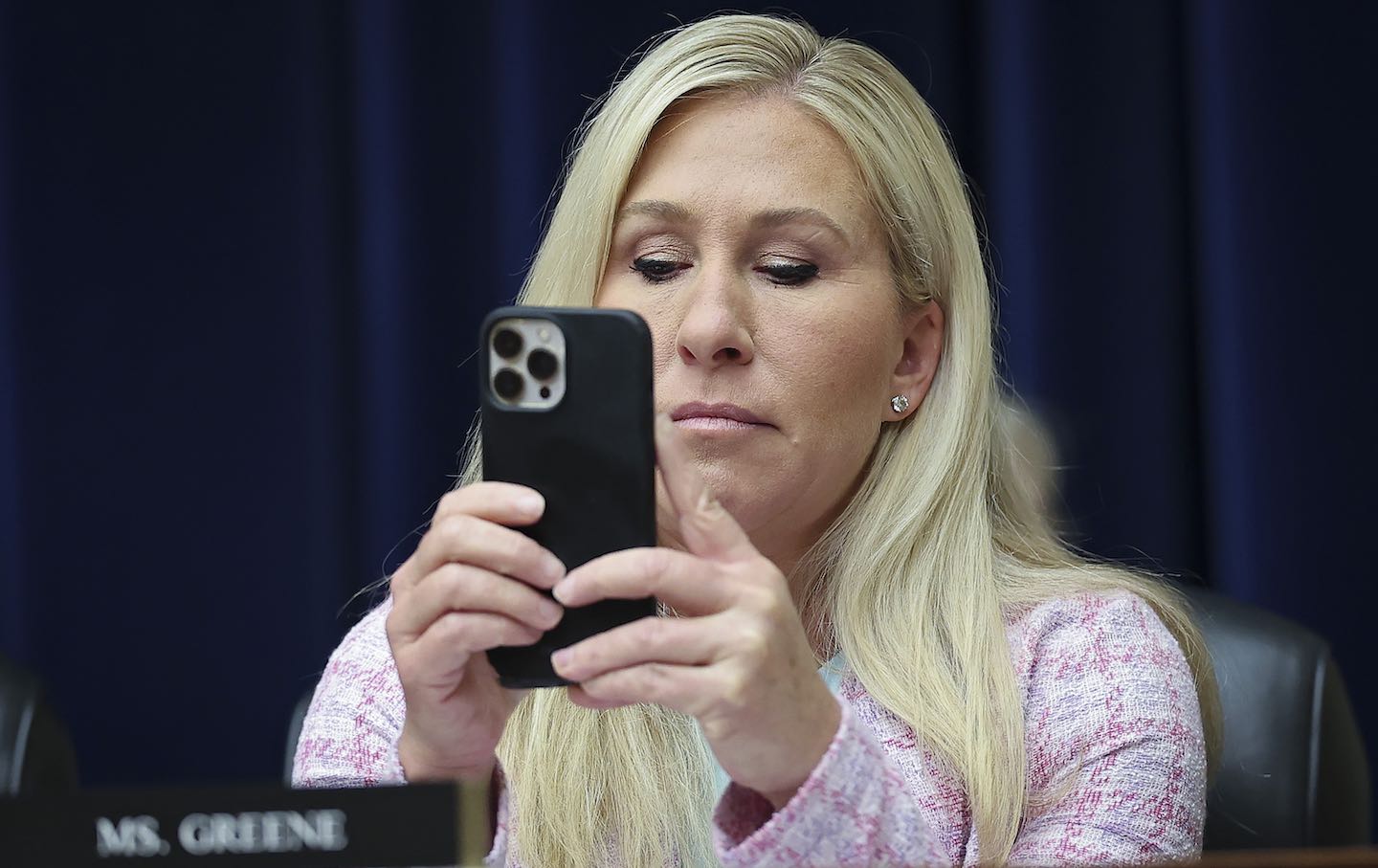 Representative Marjorie Taylor Greene (R-Ga.) uses her phone while attending a hearing held by the House Select Subcommittee on the Coronavirus Pandemic April 18, 2023 in Washington, D.C.