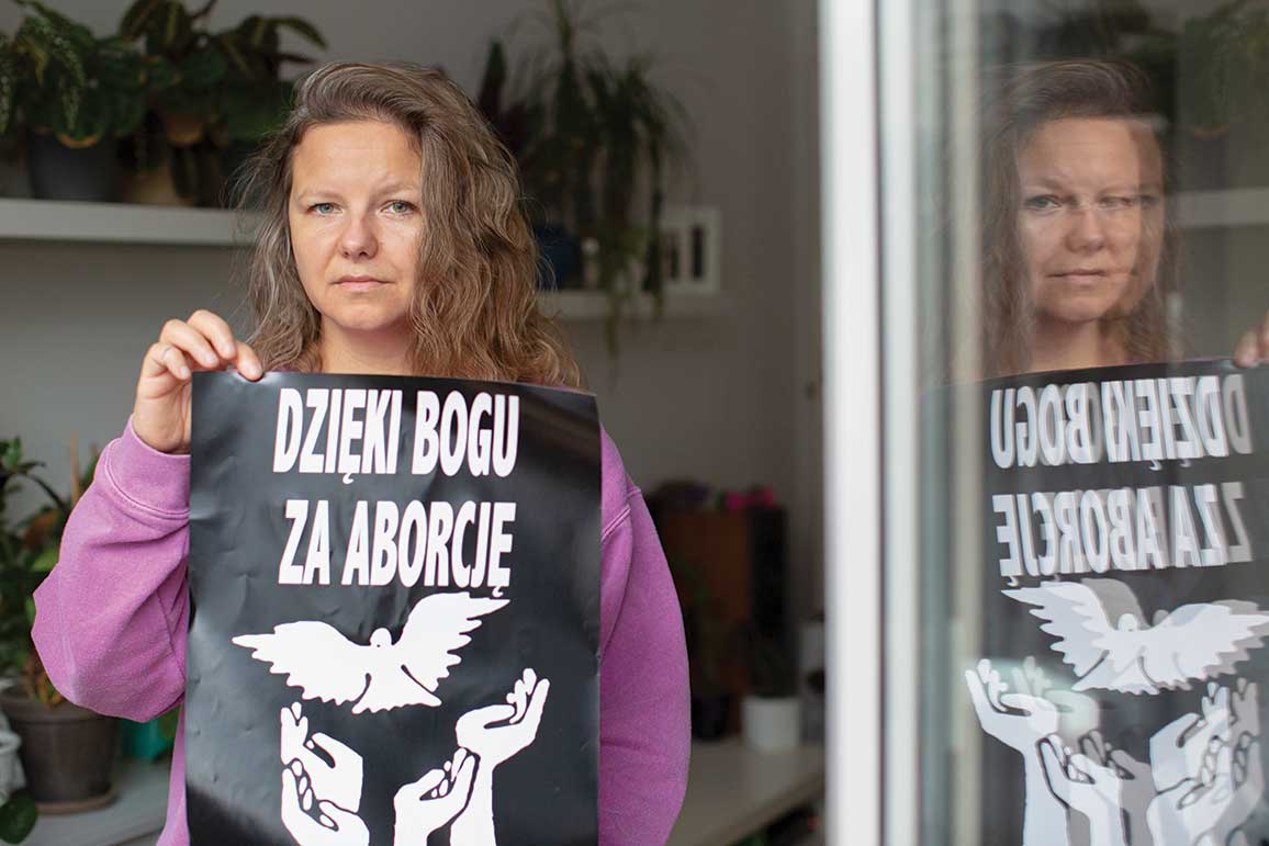 Natalia Broniarczyk, one of the founders of the Abortion Dream Team, holds a banner that reads “Thank God for Abortion.”