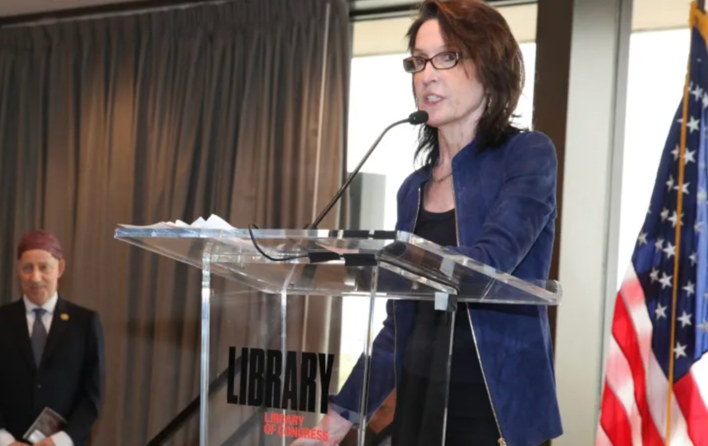 Katrina vanden Heuvel giving her acceptance speech. IPS Senior Adviser John Cavanagh (left) and Representative Jamie Raskin (right) look on in the background.