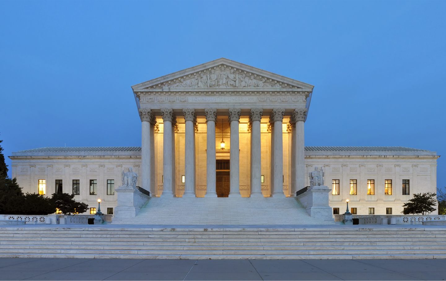 The west facade of the Supreme Court Building in Washington, D.C., at dusk.
