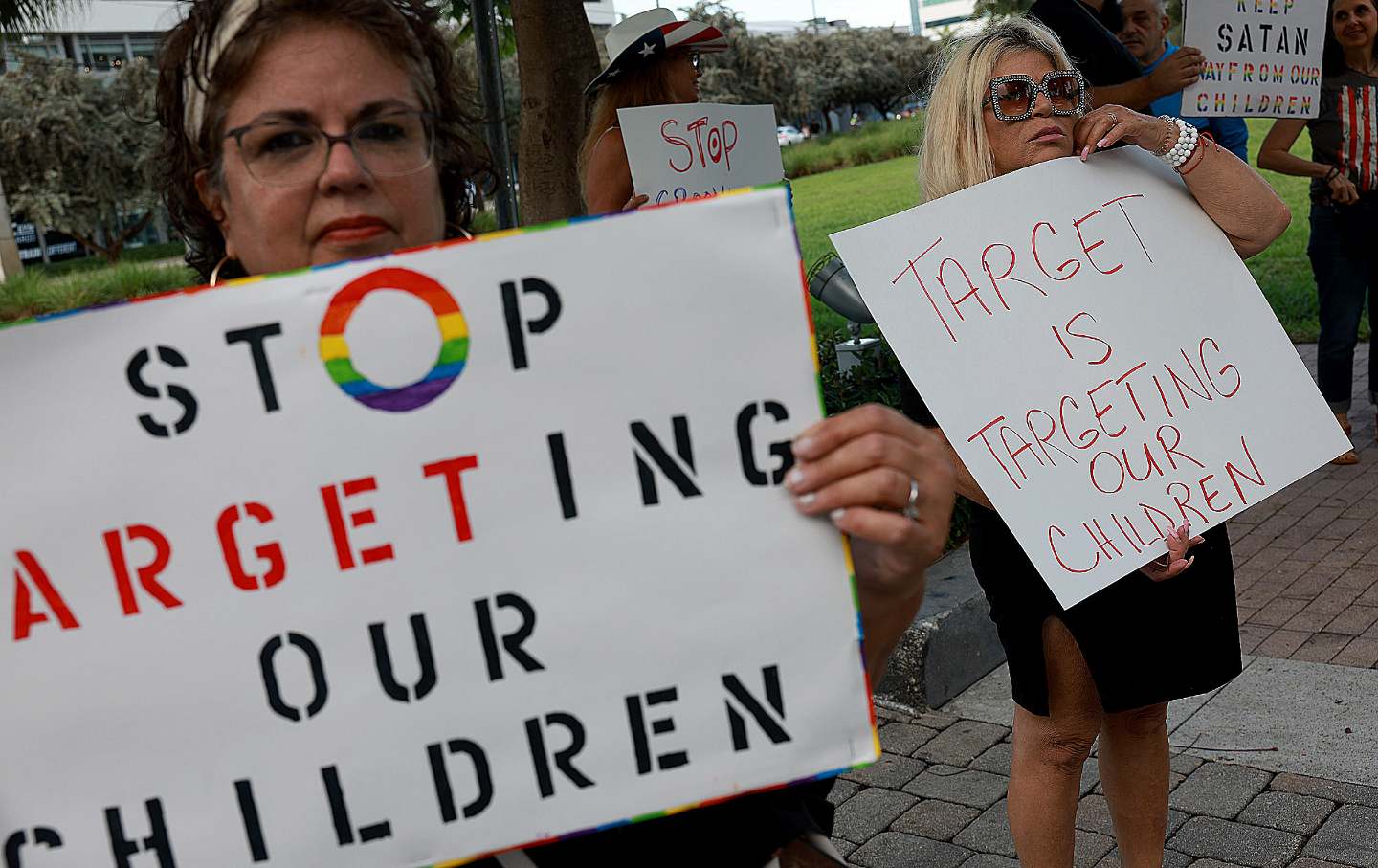 Two protesters hold signs opposing Target’s 