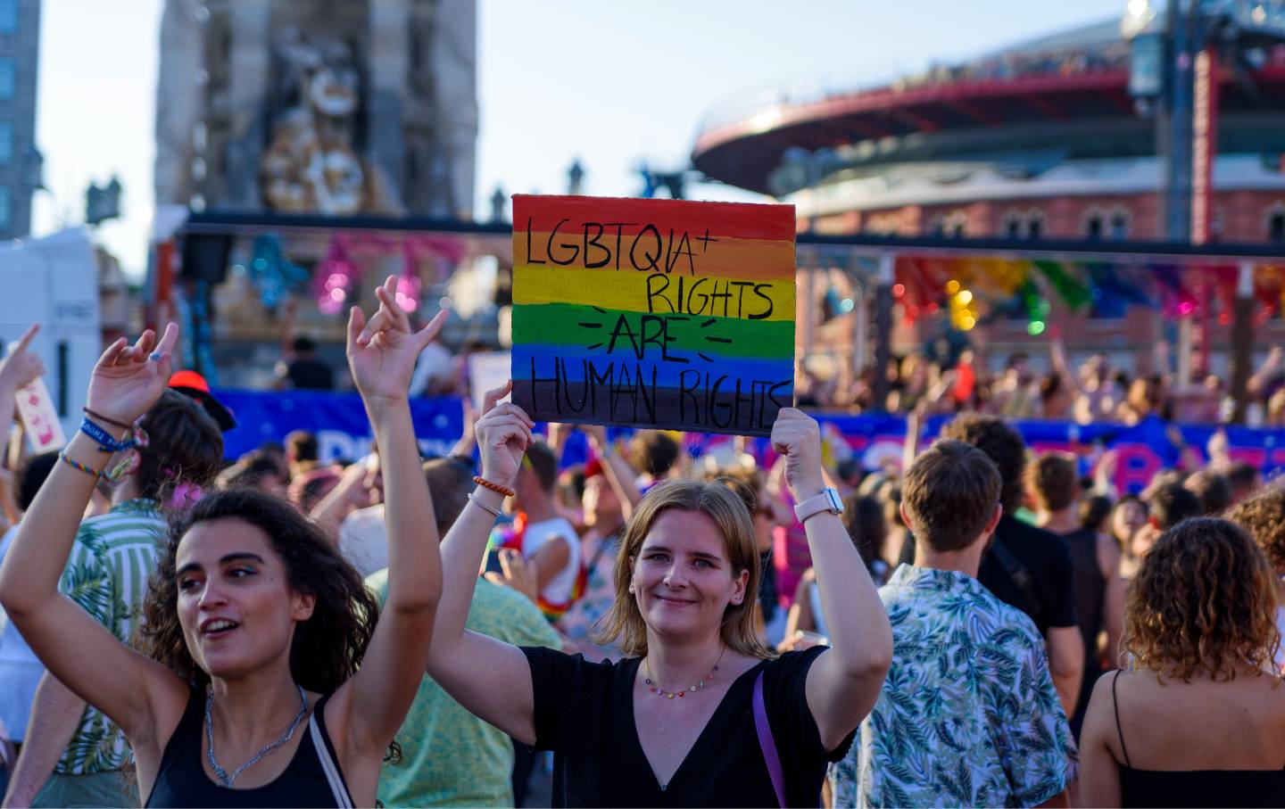 A person holds a sign reading 