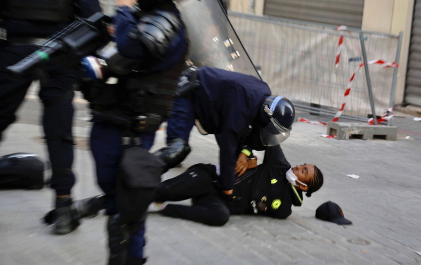 Armed French police use force against civilian, force him on to the ground