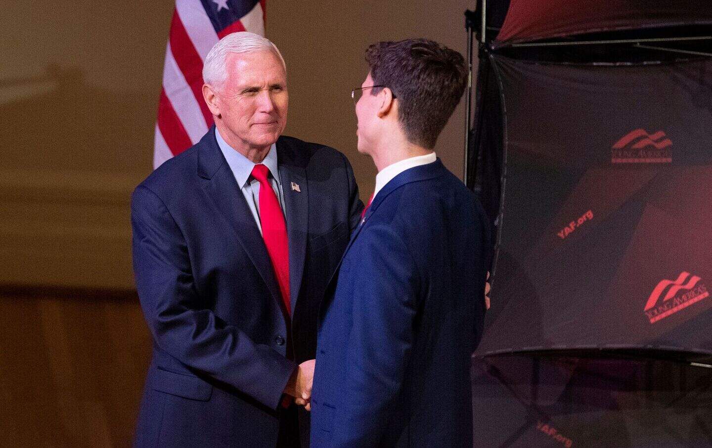 Former US vice president Mike Pence (L) is greeted by Young Americans for Freedom chair Nick Cabrera