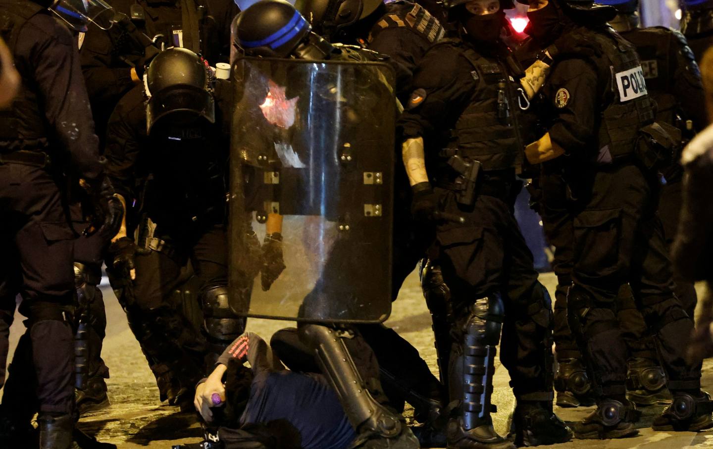 French police officers detain a demonstrator in Paris on July 2, 2023.
