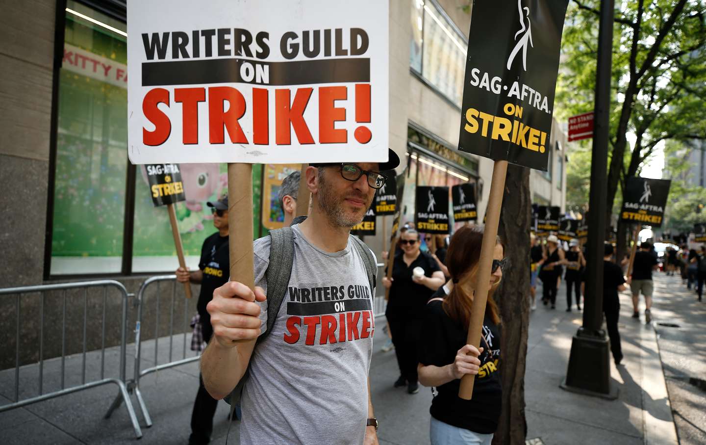 SAG-AFTRA and Writers Guild of America members picket in front of 30 Rockefeller Plaza on July 17, 2023.
