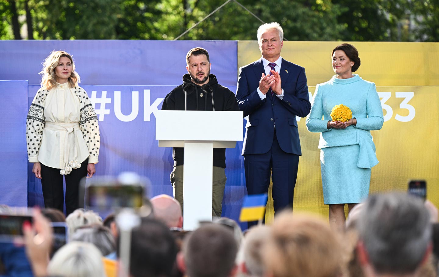 Ukrainian President Volodymyr Zelenskyy, Lithuanian President Gitanas Nauseda, Lithuanian first lady of Lithuania Diana Nepaite, and Ukrainian first lady Olena Zelenska stand together on the stage during the “Raising the Flag for Ukraine” NATO event on July 11, 2023, in Vilnius, Lithuania.