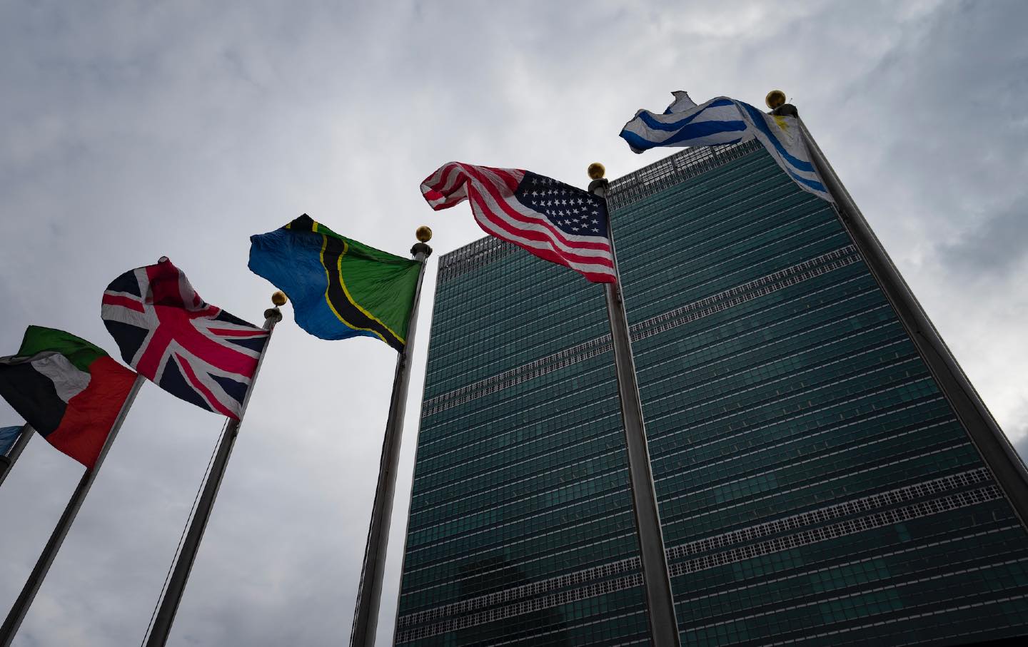 Row of flags, including US flag, outside United Nations building