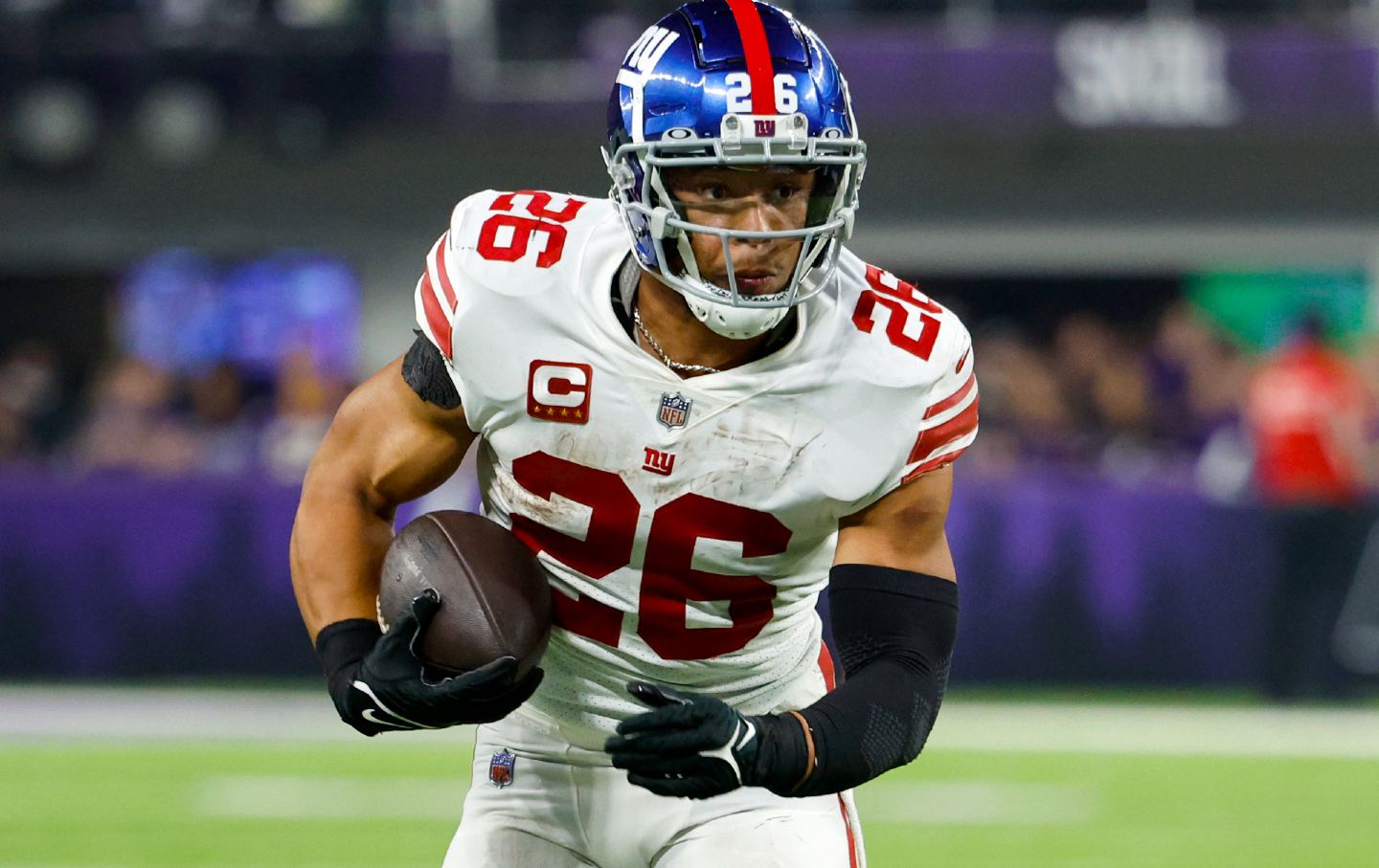 Saquon Barkley of the New York Giants runs down the field holding football