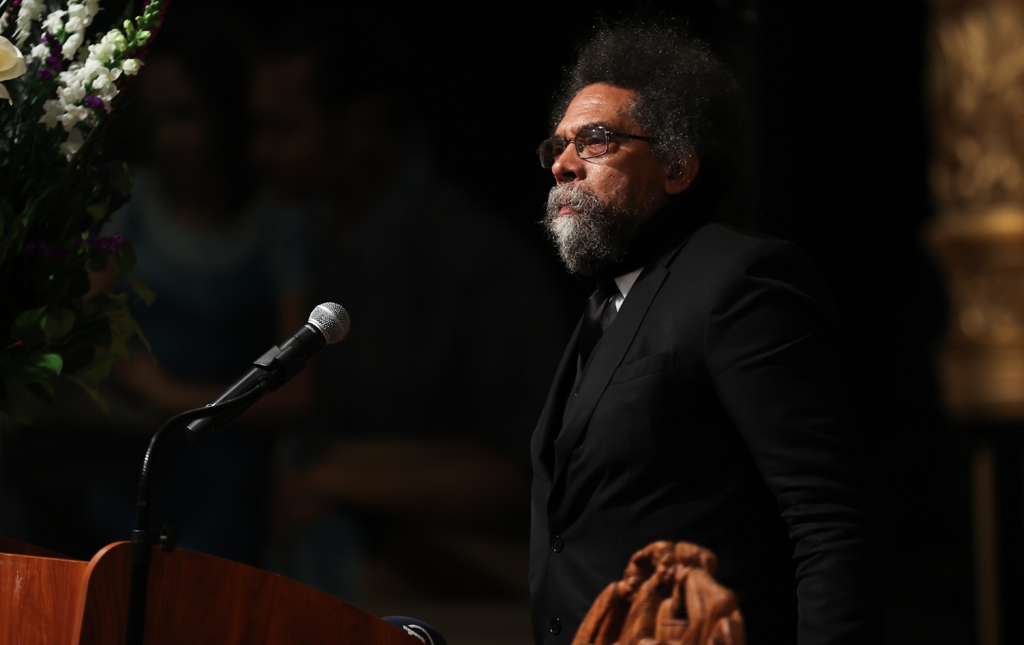 Cornel West speaking at a lectern