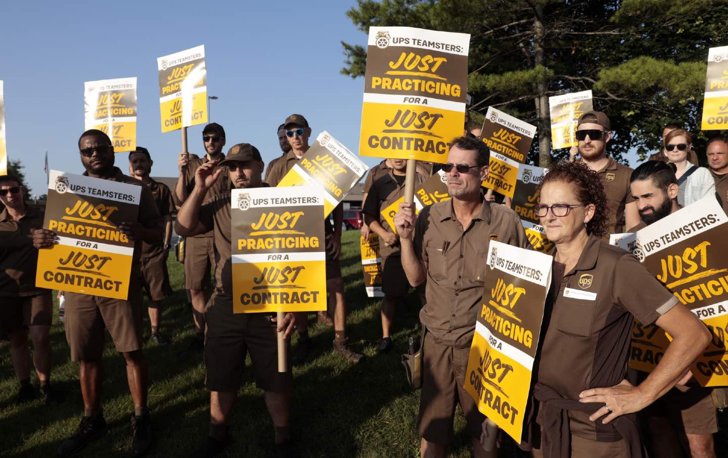 UPS workers and Teamsters members practice picket, hold signs