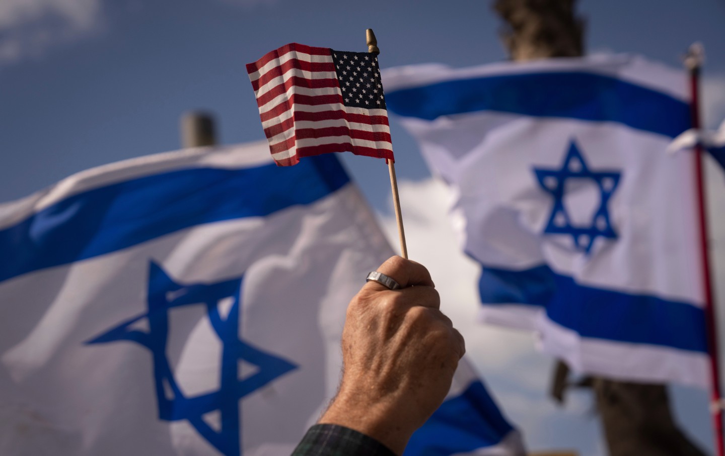 An Israeli waves a US flag during a protest against the government's judicial overhaul on Thursday, March 30, 2023.