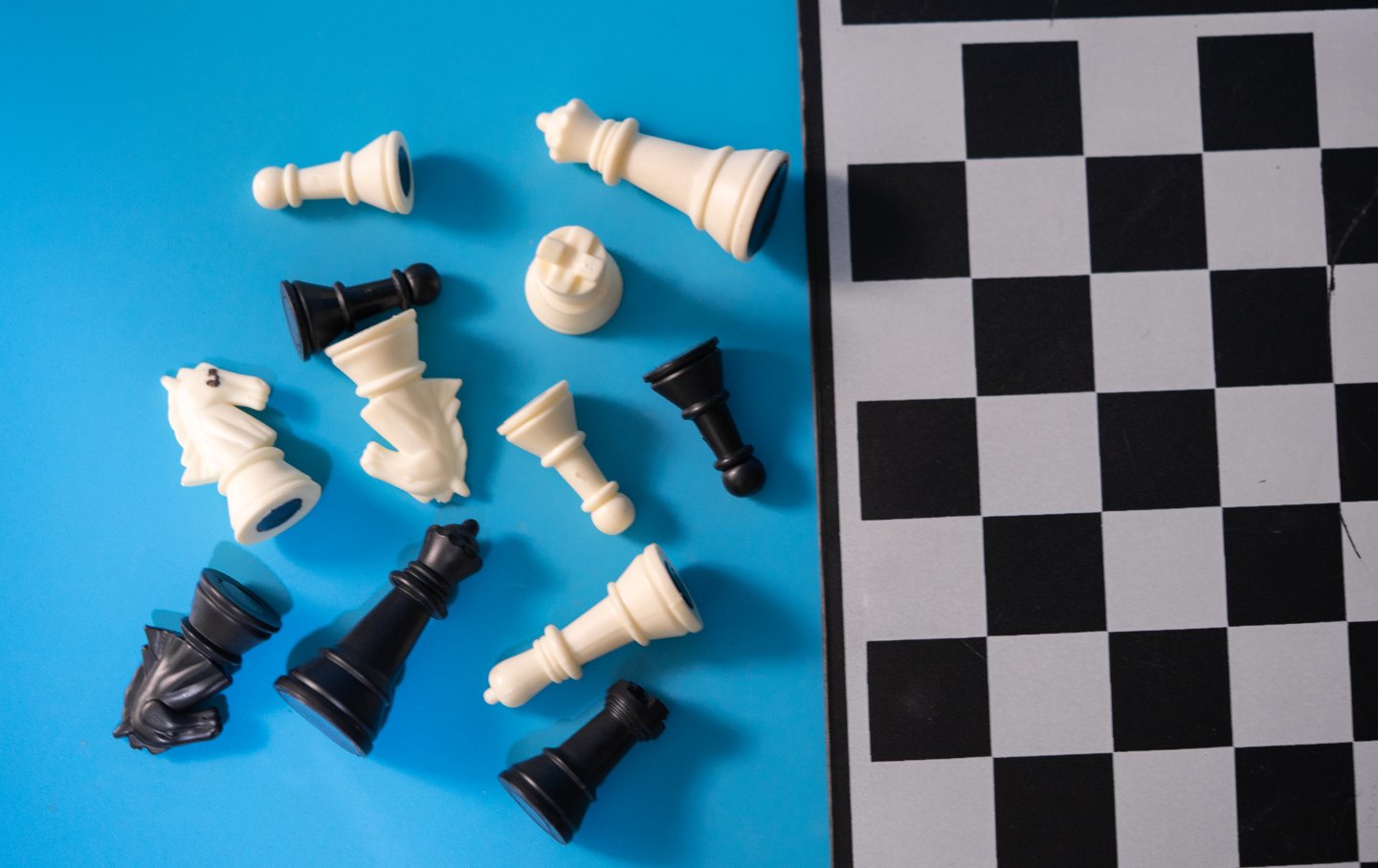 Image of chess pieces lying in disarray on the floor.