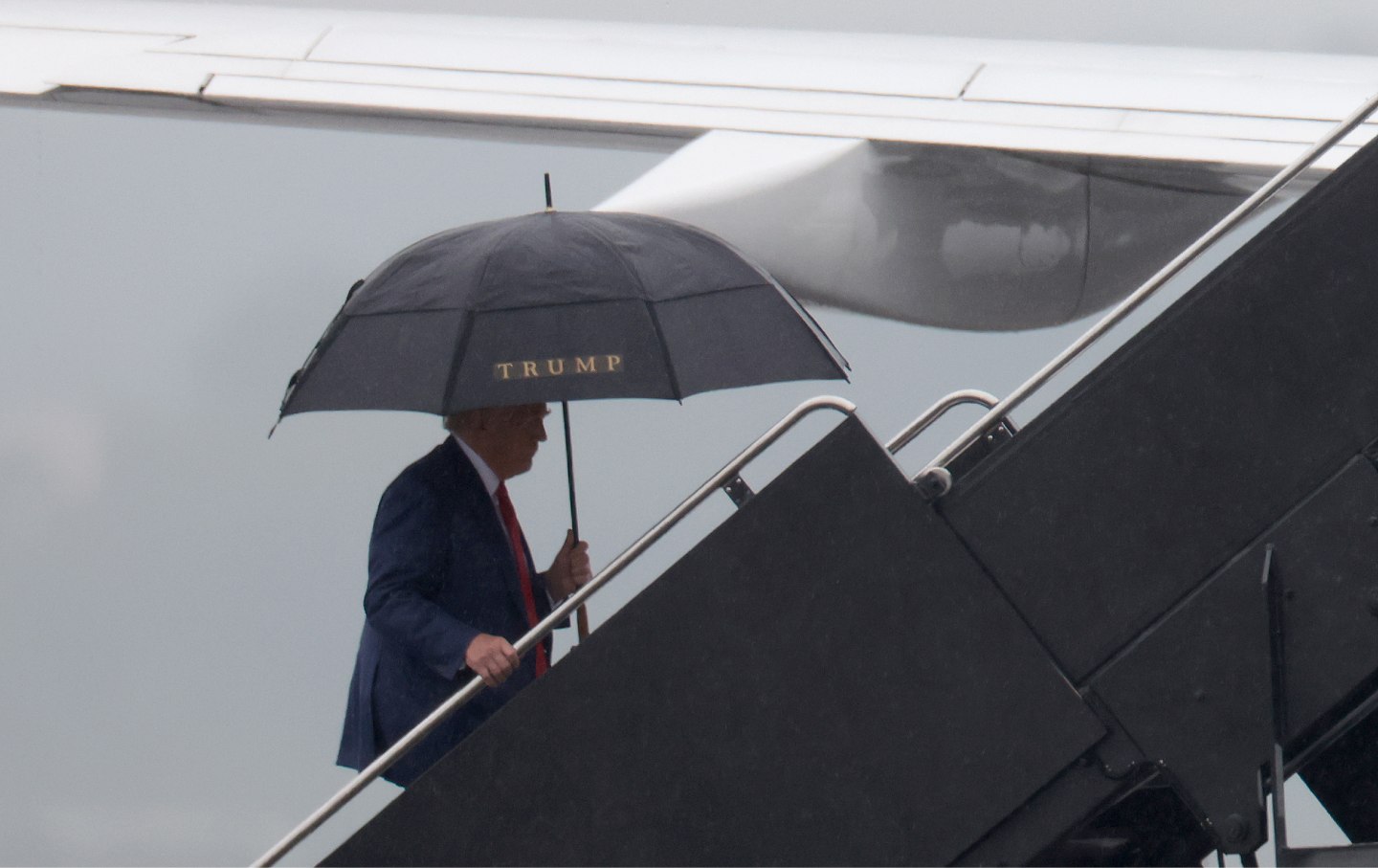 Former U.S. President Donald Trump boards his plane at Reagan National Airport following an arraignment in Washington, D.C. federal court on August 3, 2023.