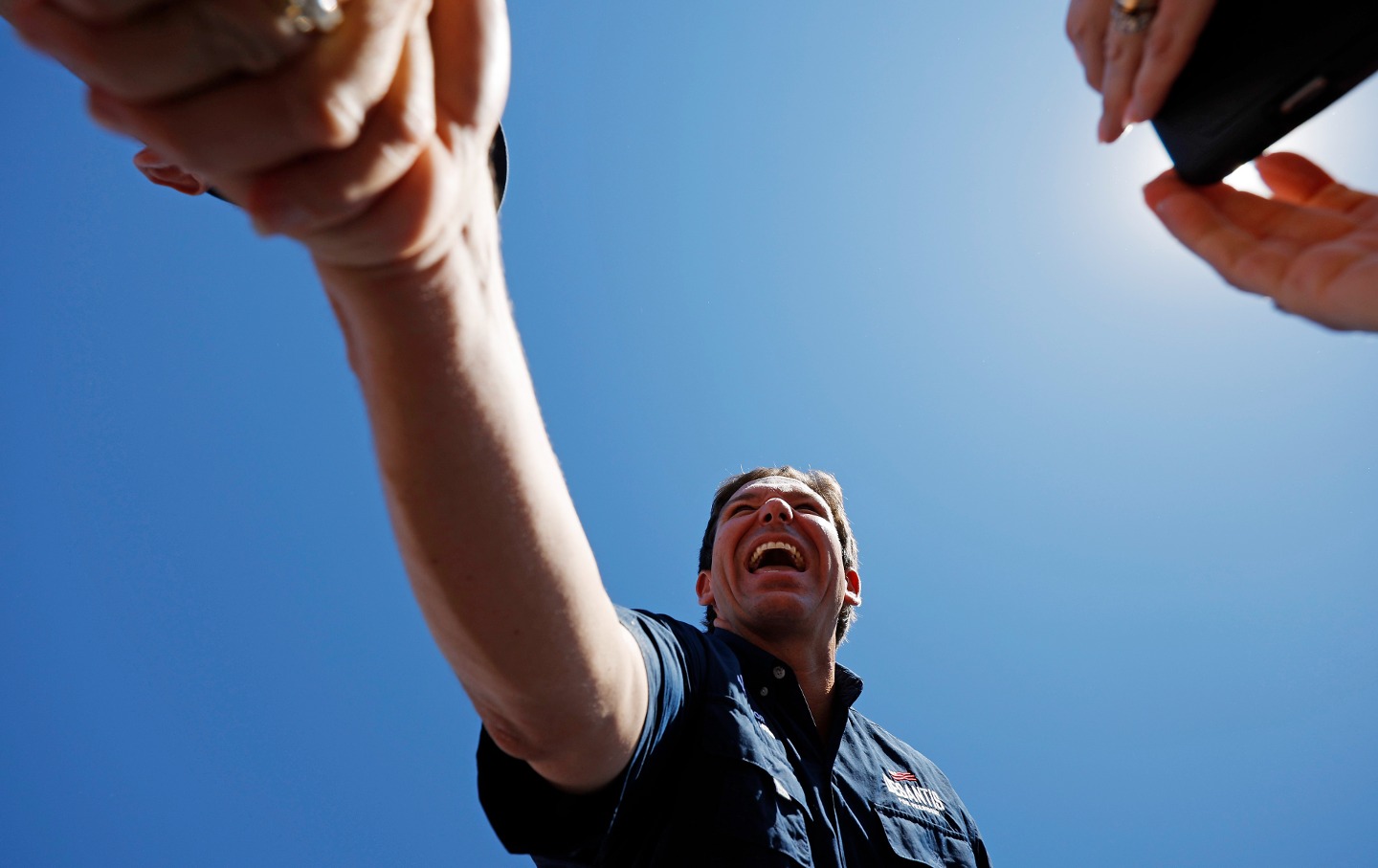 Ron DeSantis shakes hands with supporters at the conclusion of one of Iowa Governor Kim Reynolds' 