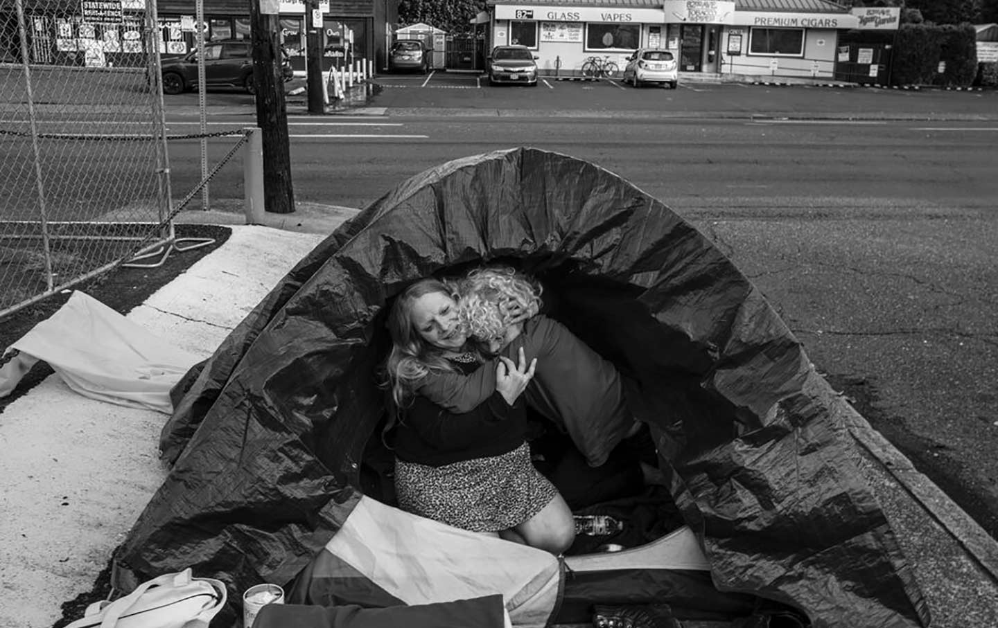 Gavin Kelly and his mother Amanda hug, inside the tent they live in, off a side road in a SE neighborhood of Portland, Ore., on November 1, 2022.