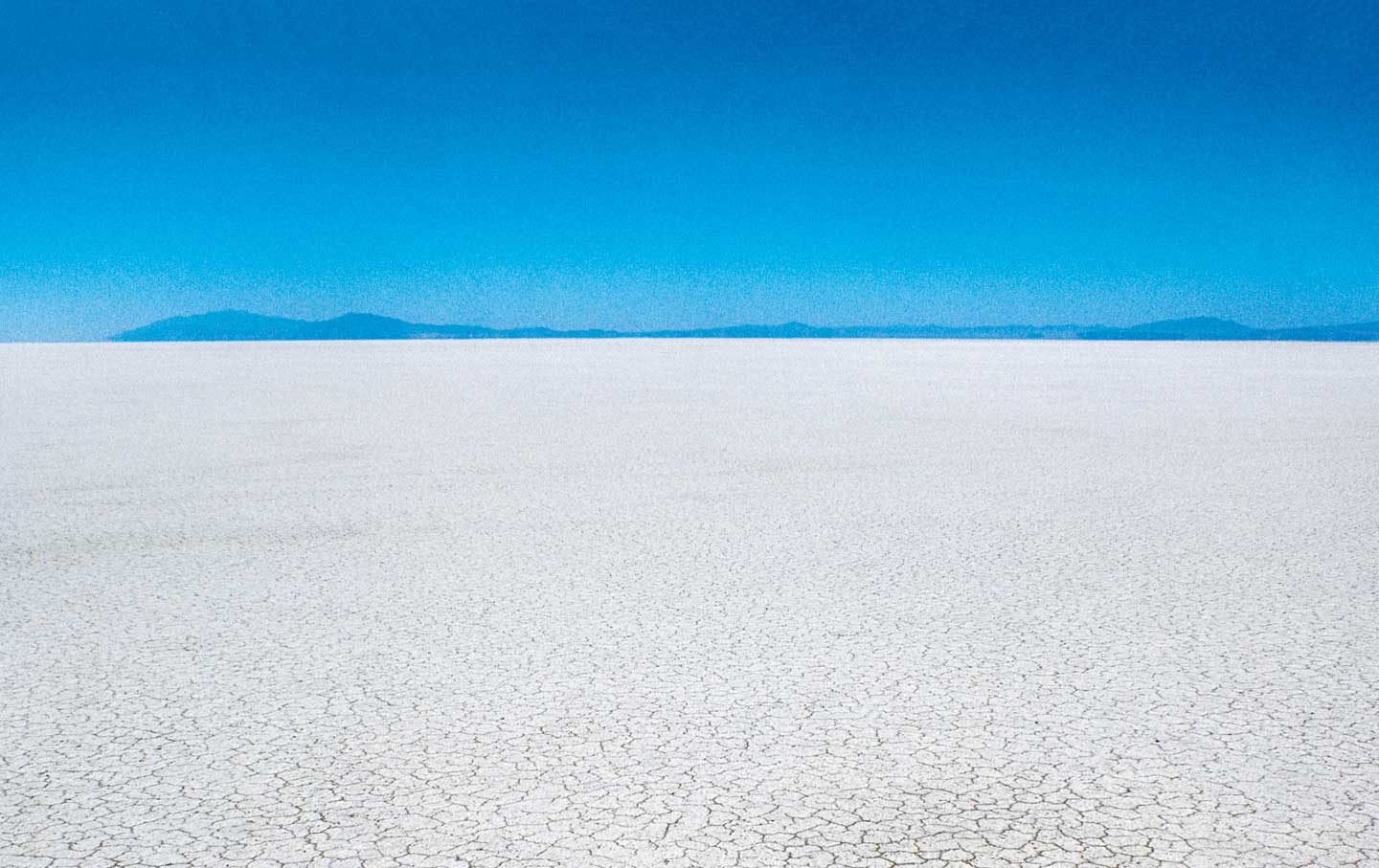 Where there was once water in abundance, there is now just the dry, cracked, exposed lake bed.