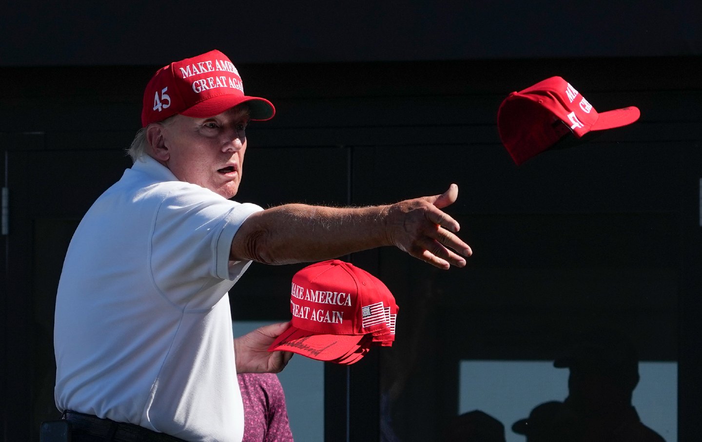 Donald Trump throwing hats at crowd