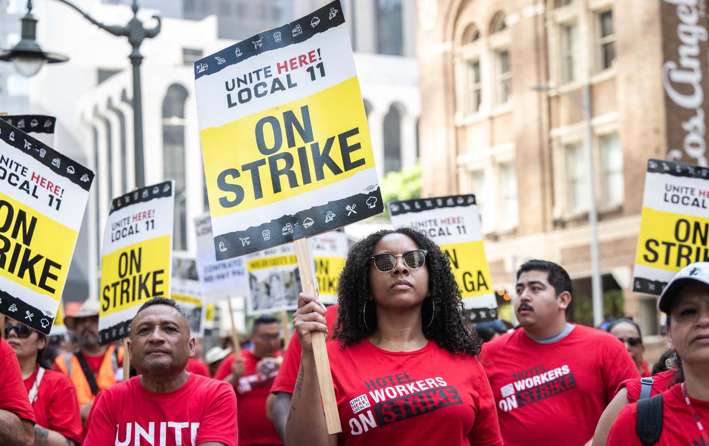 Striking hotel front desk agent Lauren Lesure, center, and other hotel workers and their supporters rally at the InterContinental Los Angeles Downtown hotel in Los Angeles on Monday, August 7, 2023.