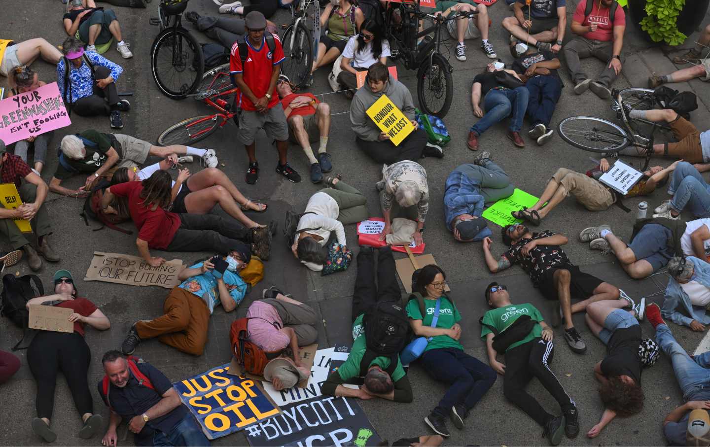 Activists lie down during a 'Rally for Climate Sanity' outside Calgary's Town Hall in opposition to the 24th World Petroleum Congress Opening Ceremony, on September 17, 2023, in Calgary, Canada.