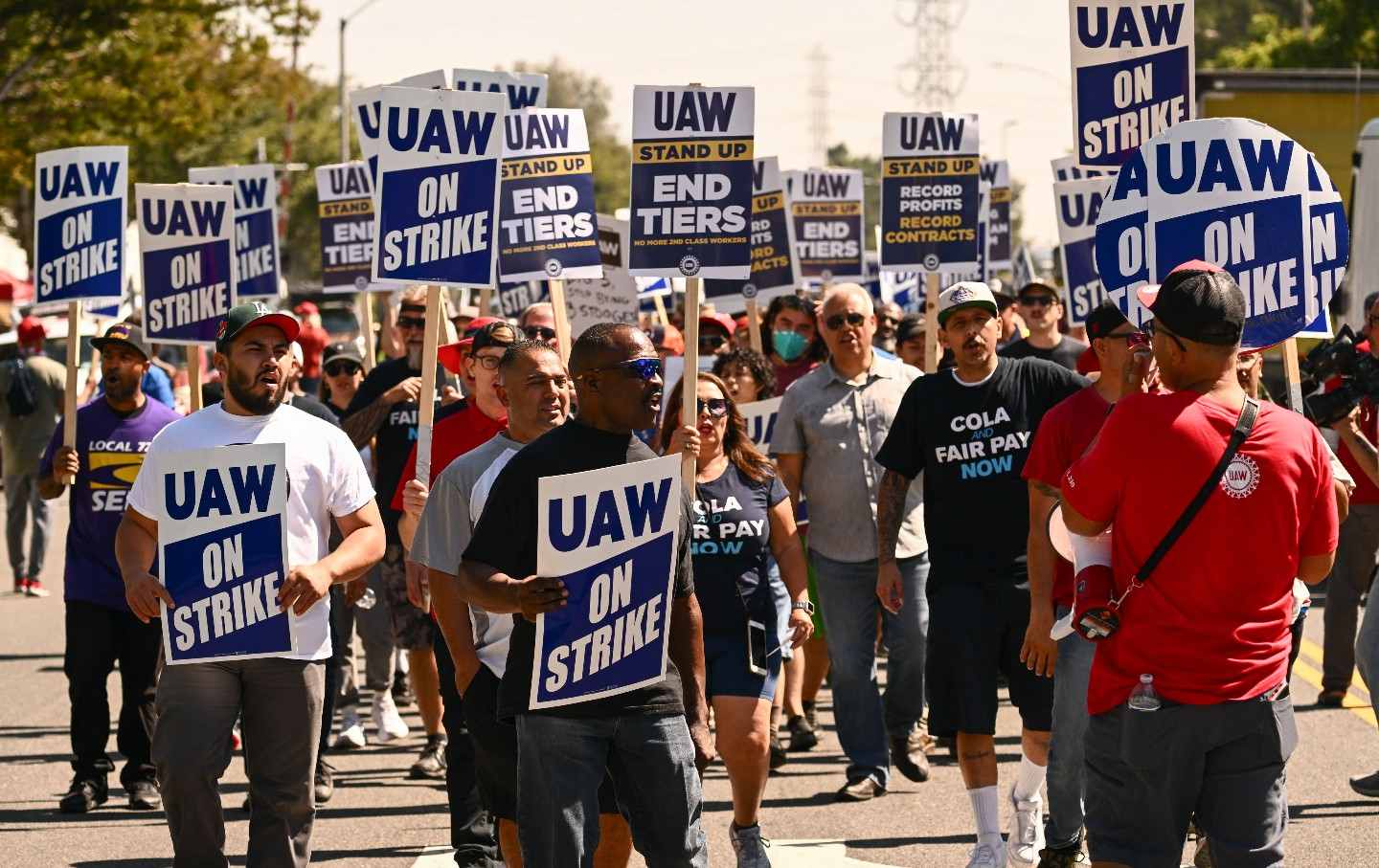 Members of the United Auto Workers Local 230 walk the picket line in front of the Chrysler Corporate Parts Division in Ontario, California, on September 26.