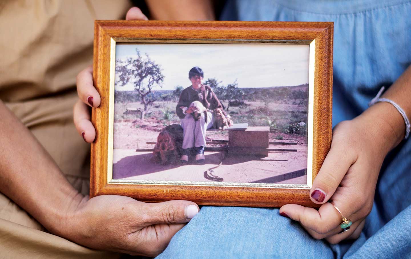 Mara Marques Cavallaro holding a photo of her grandmother.