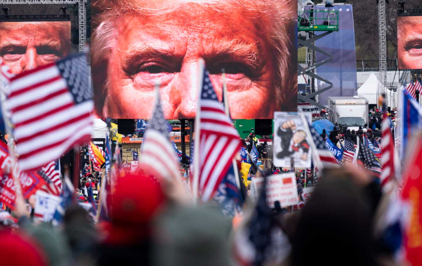 An image of President Donald Trump looms over crowds of supporters before his speech from the Ellipse at the White House on Wednesday, January 6, 2021.