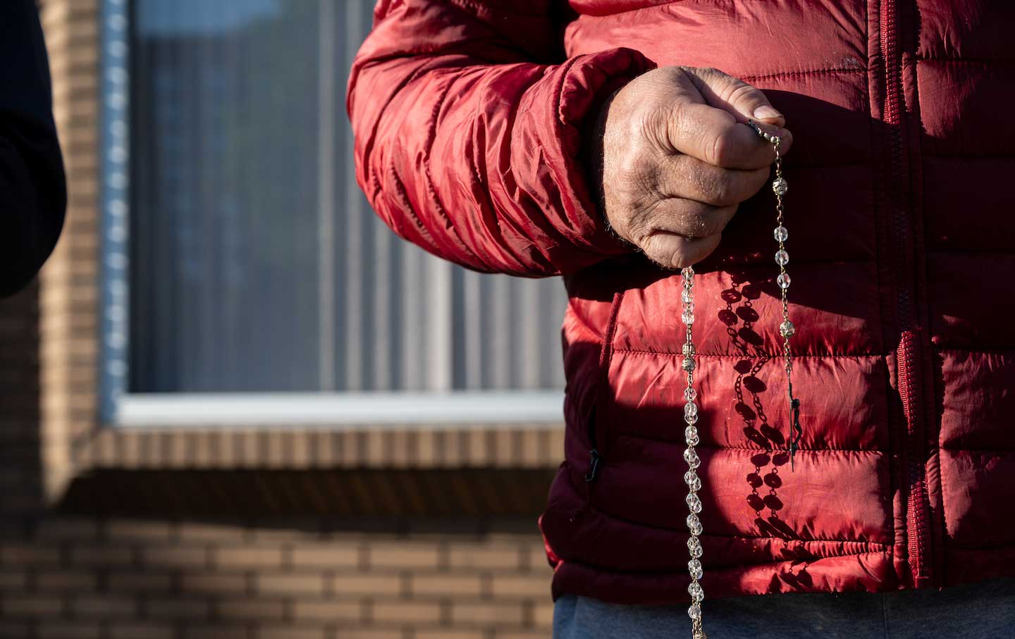 An anti-abortion demonstrator clutches prayer beads and prays with other protesters in front of the EMW Womens Surgical Center on May 8, 2021, in Louisville, Ky.