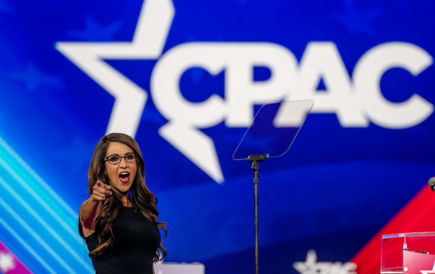 Lauren Boebert points toward the crowd onstage