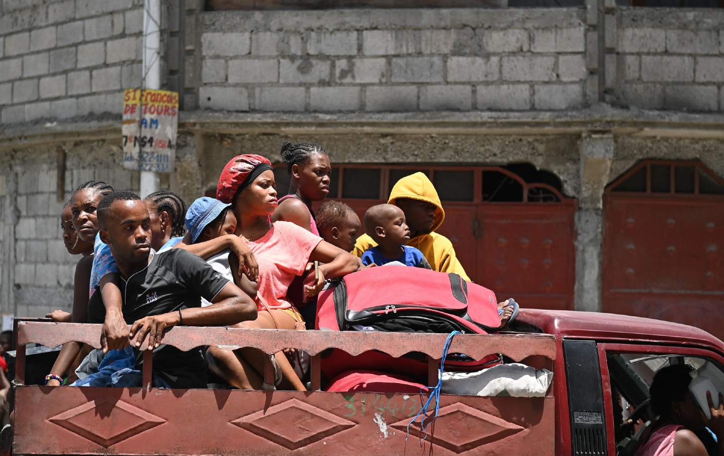 Port-au-Prince residents evacuate the city in a truck