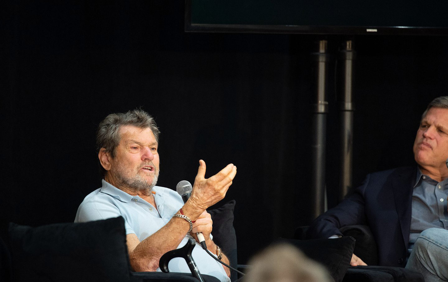 Jann Wenner seated onstage, speaking.