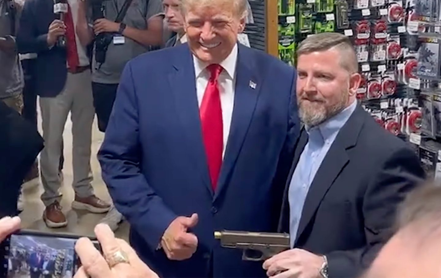 Donald Trump poses for a picture at a South Carolina gun store.