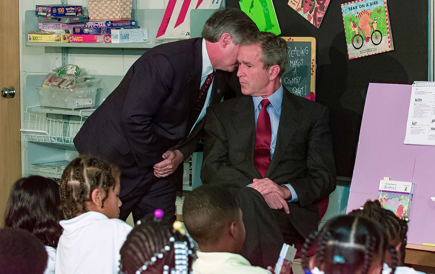 White House chief of staff Andrew Card whispers to President George W. Bush news that two planes have crashed into the World Trade Center, on September 11, 2001.
