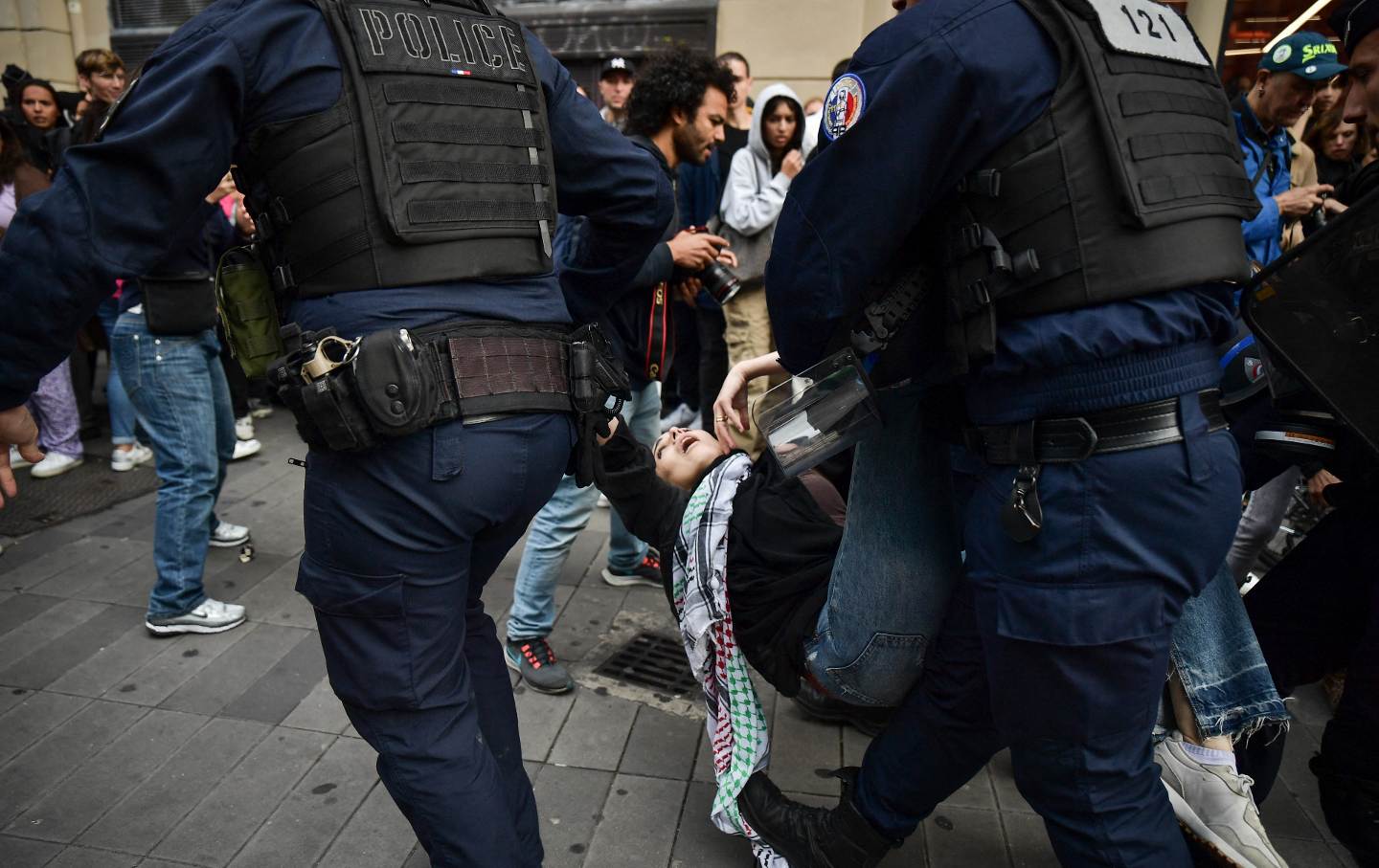 Riot police arrest a protester during a demonstration in solidarity with Palestine at the Place de la Republique in Paris, France, on October 14, 2023
