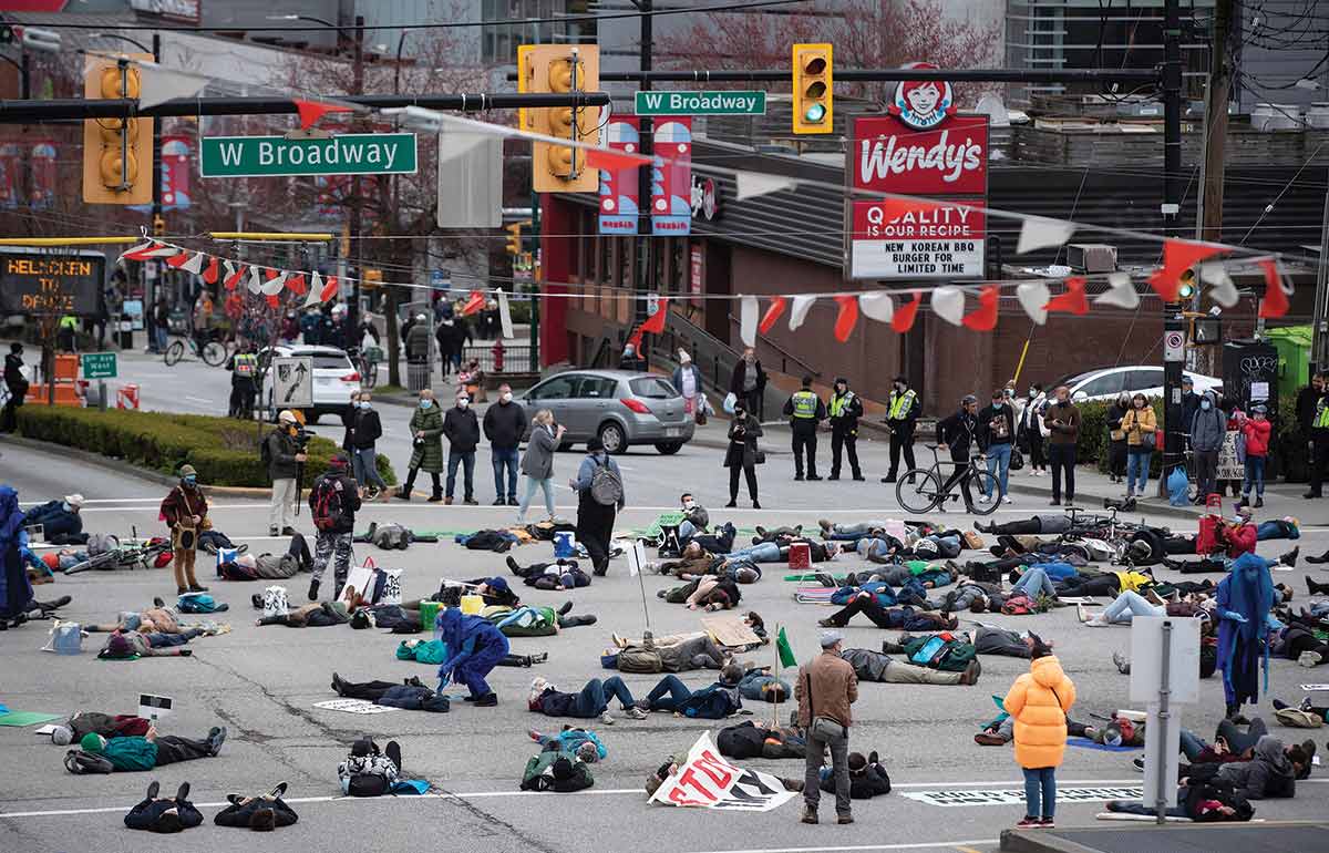 Members of Extinction Rebellion and Greenpeace stage a die-in outside the Royal Bank of Canada in Montreal.